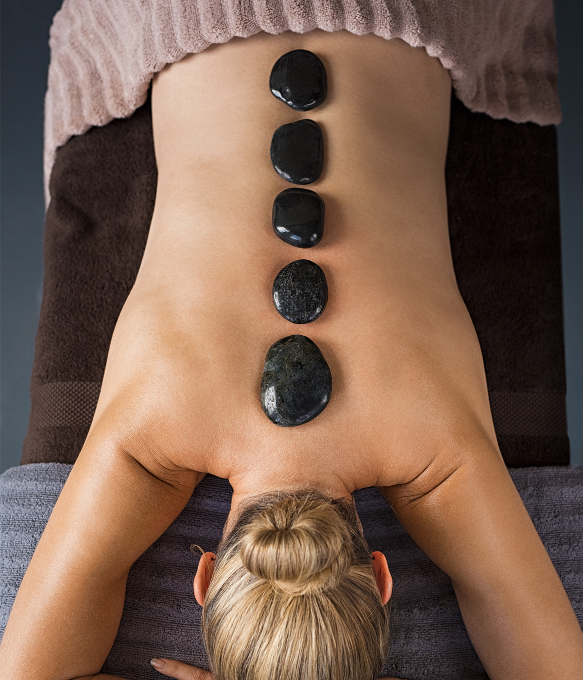 person receiving hot stone massage