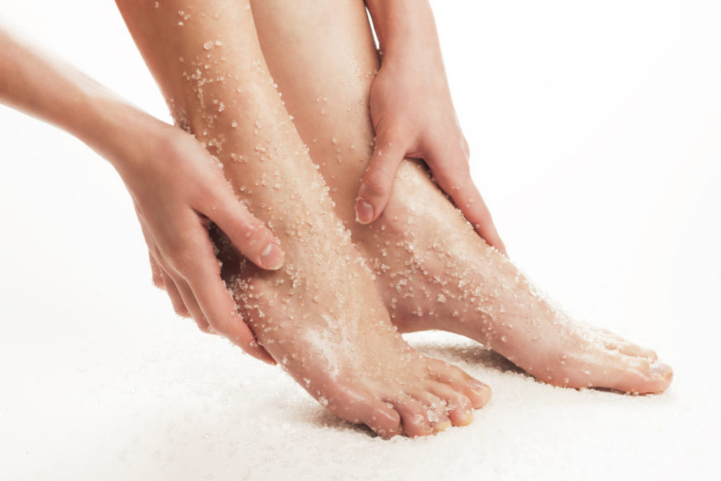 Sugar scrub being applied to feet